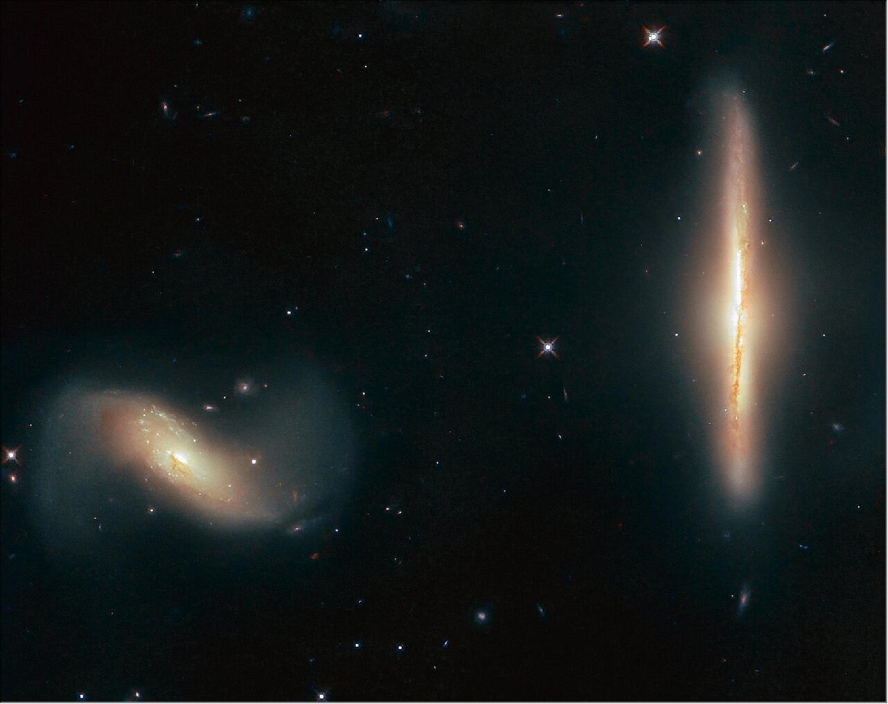 Figure 7: The two galaxies featured in this Picture of the Week, named NGC 6285 (left) and NGC 6286 (right), have done just that! Together, the duo is named Arp 293 and they are interacting, their mutual gravitational attraction pulling wisps of gas and streams of dust from them, distorting their shapes, and gently smudging and blurring their appearances on the sky — to Earth-based observers, at least (image credit: ESA/Hubble & NASA, K. Larson et al.)