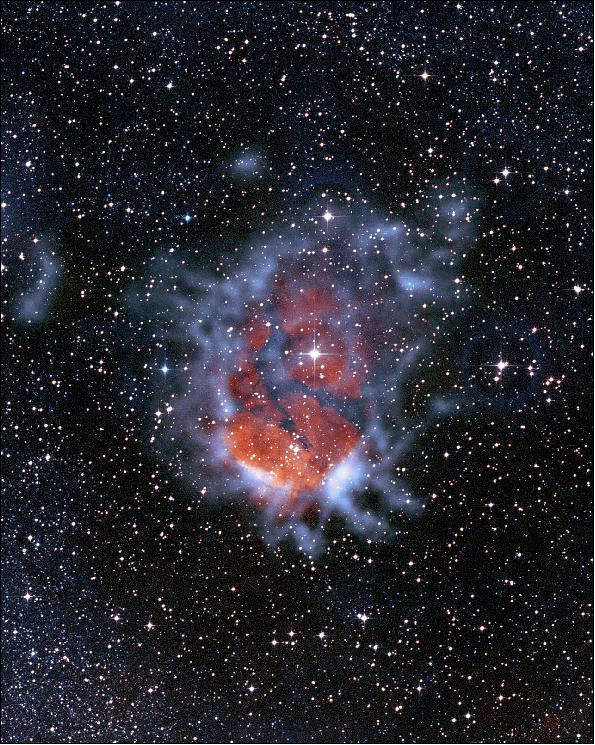 Figure 18: Color composite image of RCW120. It reveals how an expanding bubble of ionized gas about ten light-years across is causing the surrounding material to collapse into dense clumps where new stars are then formed. The 870 µm submillimeter-wavelength data were taken with the LABOCA camera on the 12 m APEX (Atacama Pathfinder Experiment) telescope. Here, the submillimeter emission is shown as the blue clouds surrounding the reddish glow of the ionized gas (shown with data from the SuperCosmos H-alpha survey). The image also contains data from the Second Generation Digitized Sky Survey (I-band shown in blue, R-band shown in red), image credit: ESO/APEX/DSS2/ SuperCosmos/ Deharveng(LAM)/ Zavagno(LAM)