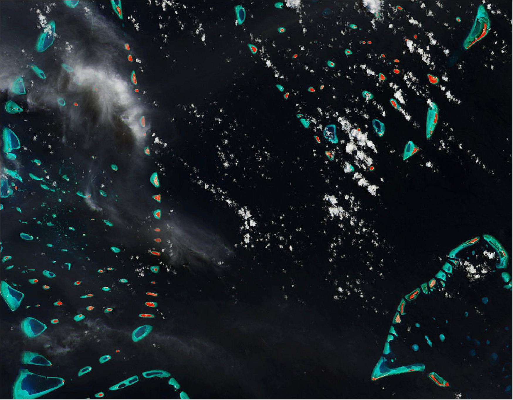 Figure 50: A number of these little islands can be seen in the image, with the turquoise colors depicting clear shallow waters dotted by coral reefs and the red colors highlighting vegetation on land. Different cloud formations can also be seen, the difference in appearance is likely to be due to the different height above the surface. This image, which was captured on 26 August 2015, is also featured on the Earth from Space video program (image credit: ESA, the image contains modified Copernicus Sentinel data (2015), processed by ESA, CC BY-SA 3.0 IGO)