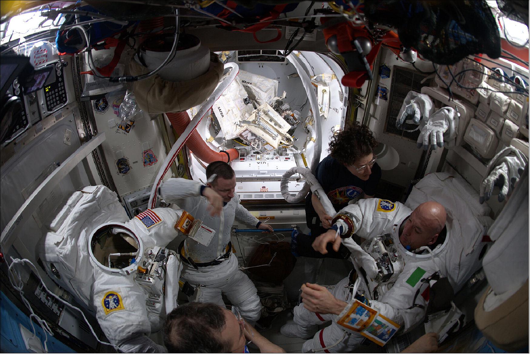 Figure 15: ESA astronaut Luca Parmitano and NASA astronaut Andrew Morgan are helped into their American EMU (Extravehicular Mobility Unit) spacesuits by NASA astronaut Christina Koch and Russian cosmonaut Oleg Skripochka ahead of the second spacewalk to service AMS-02 (image credit: ESA/NASA)
