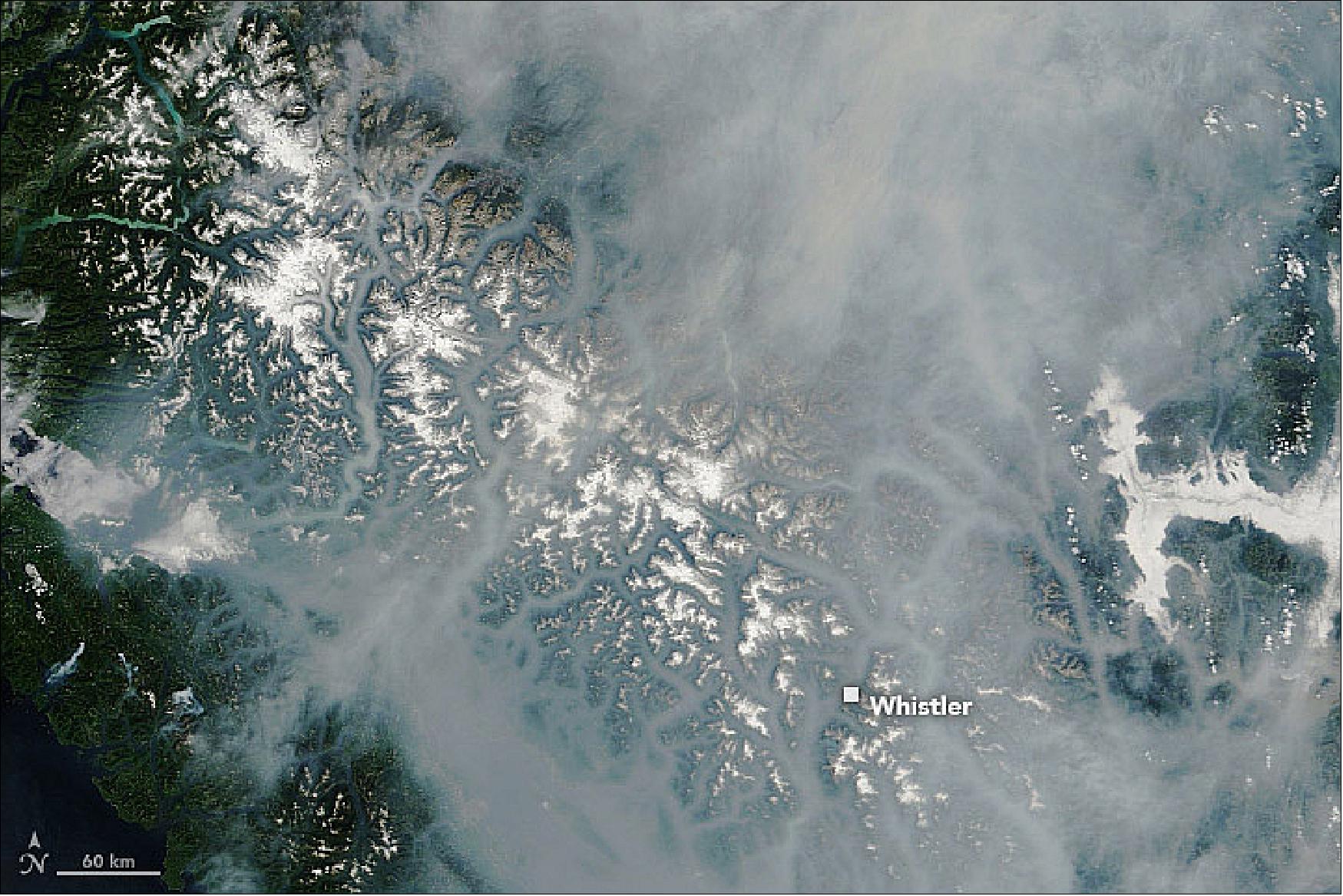 Figure 12: MODIS on Terra captured this image of British Columbia’s smoky landscape on August 13, 2018. Some of the thickest smoke lingered in the valleys, but plumes had also spread well beyond the province into Washington state and deep into the U.S. Midwest (image credit: NASA Earth Observatory, image by Lauren Dauphin using MODIS data from LANCE/EOSDIS Rapid Response, story by Adam Voiland)