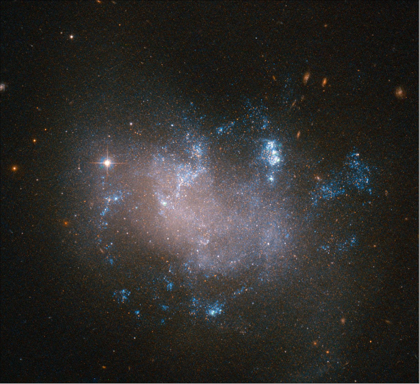 Figure 30: Glowing warmly against the dark backdrop of the Universe, this image from the NASA/ESA Hubble Space Telescope shows an irregular galaxy called UGC 12682. Located approximately 70 million light-years away in the constellation of Pegasus (The Winged Horse), UGC 12682 is distorted and oddly-structured, with bright pockets of star formation (image credit: ESA/Hubble & NASA, CC BY 4.0)