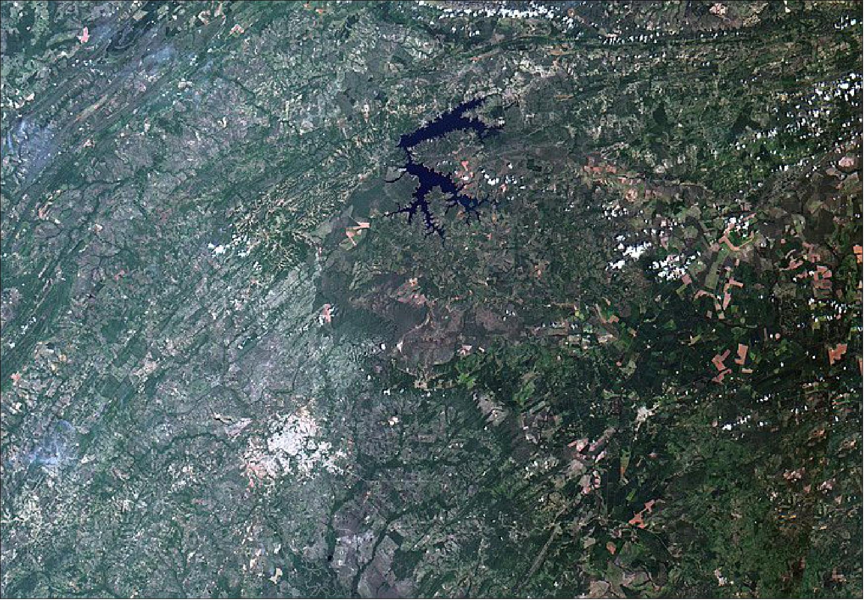 Figure 4: WFI image: Composition of real colors, 55 m spatial resolution, over an area of 330 km by 200 km. Cuiaba, the capital city of the Brazilian state of Mato Grosso, is located in the lower left (gray/white), while the Manso reservoir is visible in the top center (image credit: INPE)