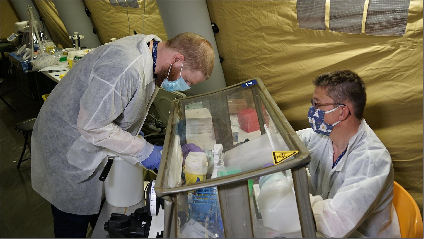 Figure 3: A sample is transferred for COVID-19 testing inside the mobile bio-lab in Piedmont (image credit: ESA)