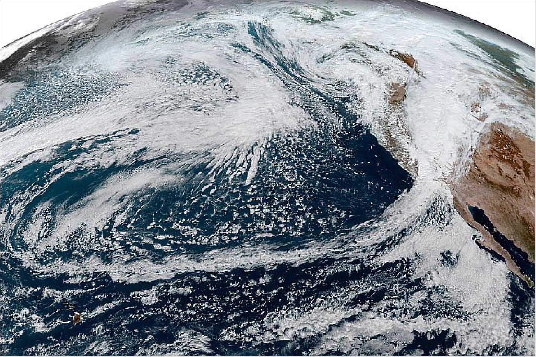 Figure 21: This simulated natural-color image, acquired on October 25 by NOAA’s Geostationary Operational Environmental Satellite 17 (GOES-17) shows an arc of clouds stretching across the Pacific—a visible manifestation of the atmospheric river pouring moisture into the Pacific Northwest. GOES-17 is operated by the National Oceanic and Atmospheric Administration (NOAA); NASA helps develop and launch the GOES series of satellites (image credit: NASA Earth Observatory)